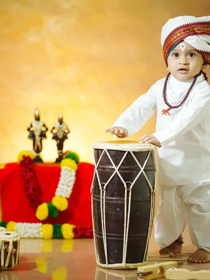 Looking up with wonder, this shot captures the innocence and curiosity of a child amidst a traditional setting.