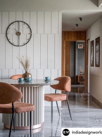 A different angle of the dining space, highlighting the material palette. The warm tones of the chairs and the cool, veined marble of the floor and tabletop create a balanced and sophisticated look, perfect for both everyday meals and entertaining.