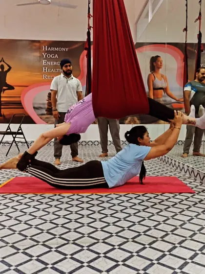 This partner pose, supported by the aerial hammock, creates long lines and a deep stretch. It's a beautiful expression of trust and coordination.