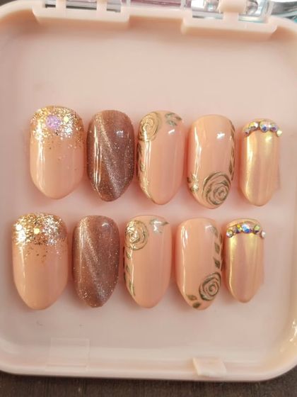 A clear, top-down view of the engagement nail set. You can see the mix of textures and finishes, from the smooth cat eye to the sparkling glitter and detailed rose art.