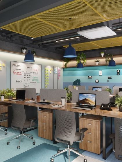 A view of the workstation clusters in our office design. We used low partitions to maintain an open feel while providing some privacy, and incorporated a large whiteboard for brainstorming sessions, supporting a dynamic and collaborative work culture.