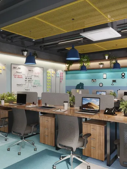 A view of the workstation clusters in our office design. We used low partitions to maintain an open feel while providing some privacy, and incorporated a large whiteboard for brainstorming sessions, supporting a dynamic and collaborative work culture.