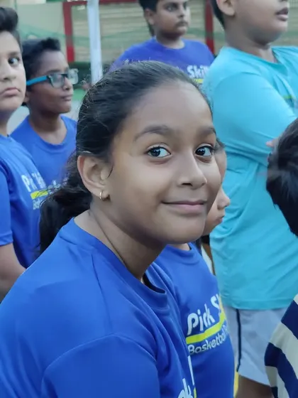 A player smiling during a break. We believe in a gentle push, letting kids discover what they enjoy in a healthy and positive environment.