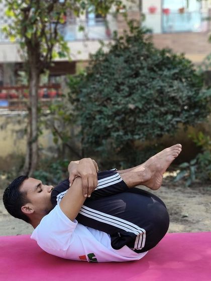 A demonstration of Pavanamuktasana (Wind-Relieving Pose). This asana is highly effective for relieving gas, bloating, and other digestive discomforts by massaging the abdominal organs.