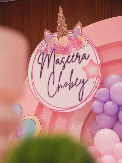 A detailed shot of the personalized "Maseera Chobey" sign with a unicorn horn and floral design.