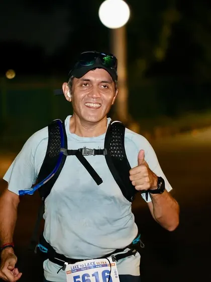 A thumbs-up during a night segment of an ultramarathon. Endurance racing requires mental toughness, especially when running through the night, and we train for that.