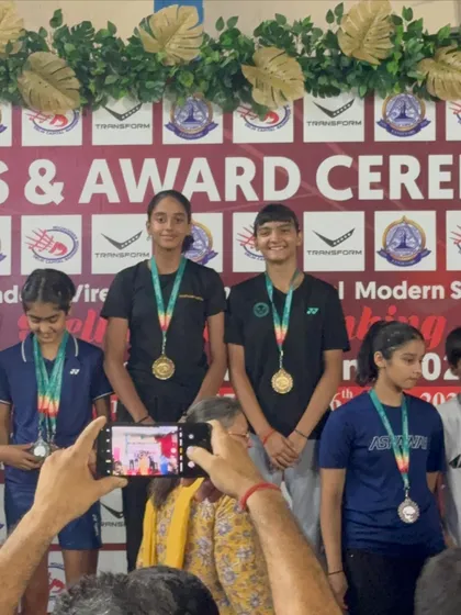 My girls on the podium after winning gold in the doubles category. Their synchronization and on-court strategy were flawless.