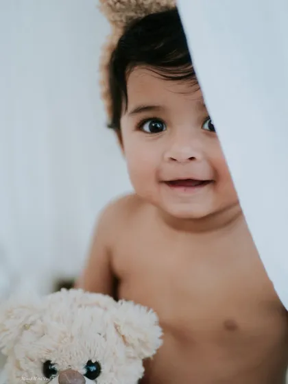 Peek-a-boo. This nine-month-old's playful smile is just infectious. Sitter sessions are so much fun, capturing them as they explore and play.