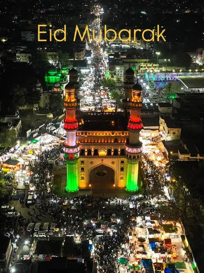 Eid Mubarak from Charminar, Hyderabad. The monument and the surrounding market are lit up for the festivities, creating a spectacular sight from above. The energy of the crowd is palpable even from the sky.