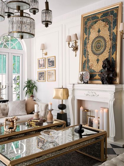 A close-up on the mantelpiece, where a framed tapestry, a classical bust, and glowing candles create a curated, artistic focal point. Every detail is chosen to contribute to the room's story.