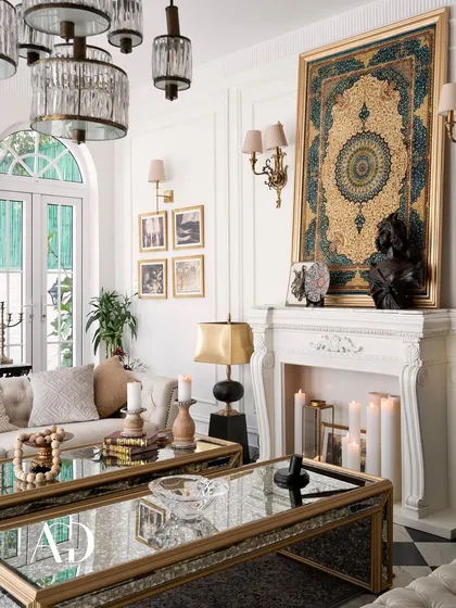 A close-up on the mantelpiece, where a framed tapestry, a classical bust, and glowing candles create a curated, artistic focal point. Every detail is chosen to contribute to the room's story.
