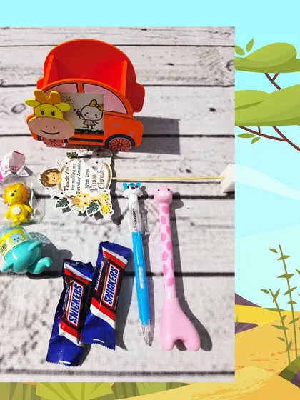 An unwrapped view of the jungle pen stand hamper, showing the car-shaped holder, giraffe pen, animal erasers, and Snickers bars.