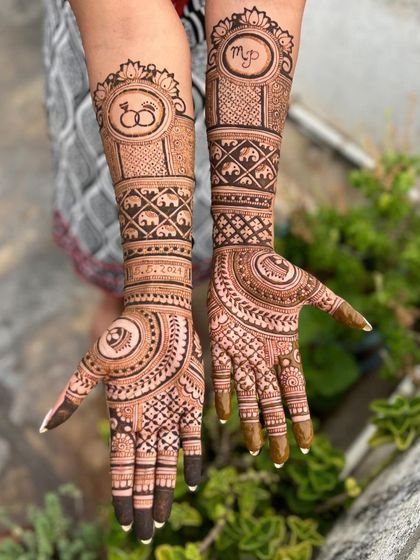A complete look at the engagement mehendi, from the fingertips to the elbow, showcasing the journey of patterns and personal elements.