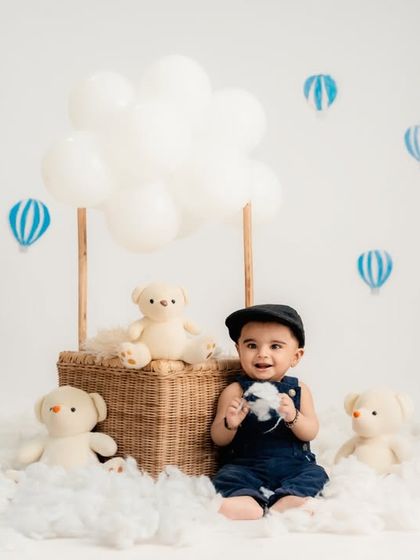 A happy smile from the little traveler in his hot air balloon basket.