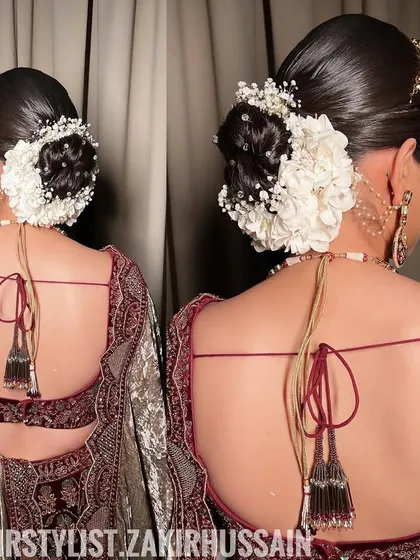 A close-up of the bridal bun, showing the intricate placement of the flowers and the sleek finish of the hair.