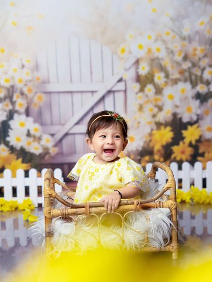 Blooming with joy in a garden of smiles. This little one's huge, happy laugh is the centerpiece of this bright and cheerful milestone session.