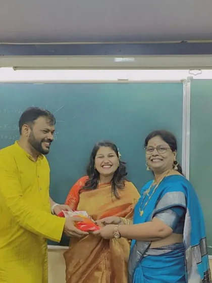 A teacher receives a Diwali gift with a bright smile. We ensure that the festive season is a time of joy and appreciation for our entire staff.