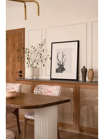 A view of the dining area in "Apartment 222," showing the harmony between the wooden furniture, paisley chairs, and the clean, paneled walls. The space feels both elegant and grounded.