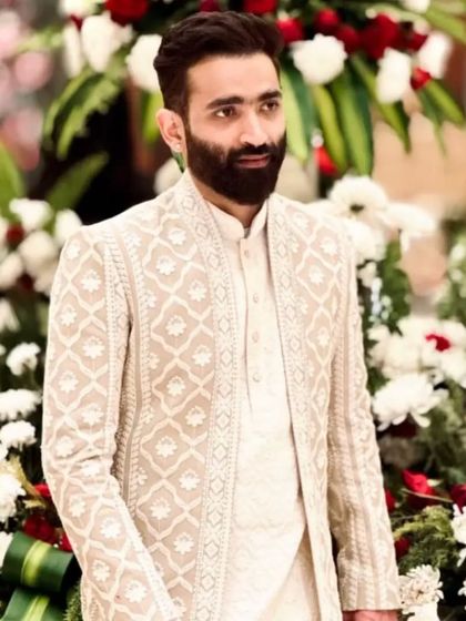 A real client looking sharp and sophisticated in one of my classic ivory Indo-Western sets. This is the timeless elegance I strive to deliver to every man.