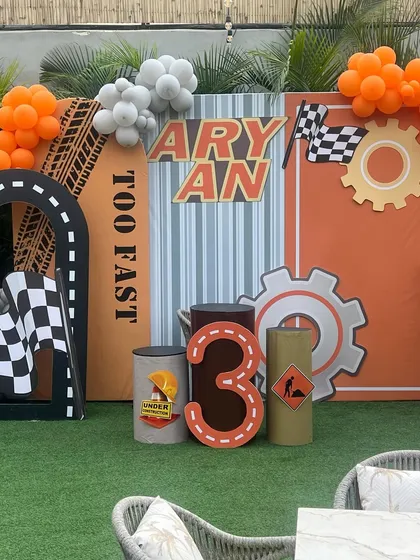 The "Too Fast" race car and construction theme is perfect for little ones who love vehicles. This photo backdrop includes personalized elements like the birthday boy's name and age.