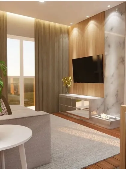 This living room design combines a wood-paneled TV wall with a marble-finish accent. The mirrored TV console adds a touch of glamour and reflects light beautifully.