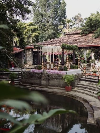 A view of the Pond Pavilion from across the water, decorated for a wedding, showing the beautiful reflections.