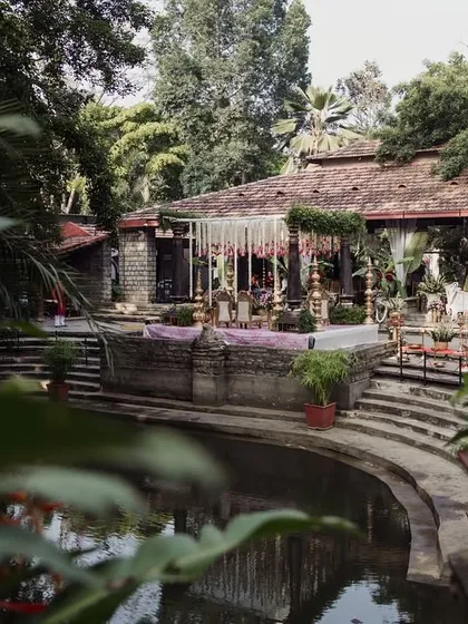 A view of the Pond Pavilion from across the water, decorated for a wedding, showing the beautiful reflections.