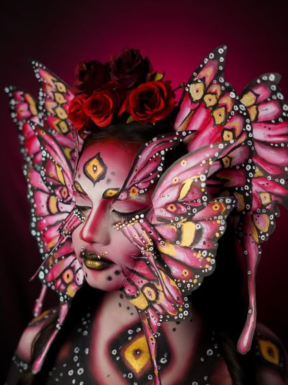 This shot showcases the intricate details of the butterfly wings painted on the face, a true work of art.