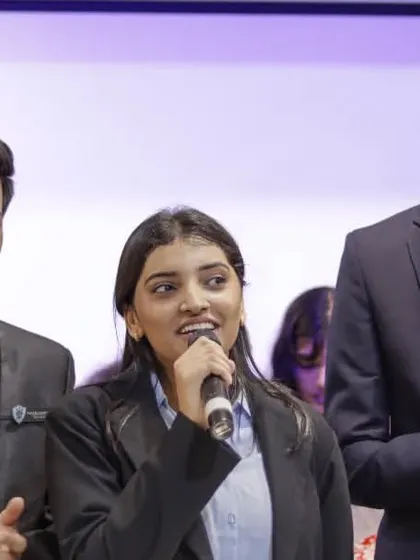Students on stage during a formal event at their college fest, showing the variety of activities covered.