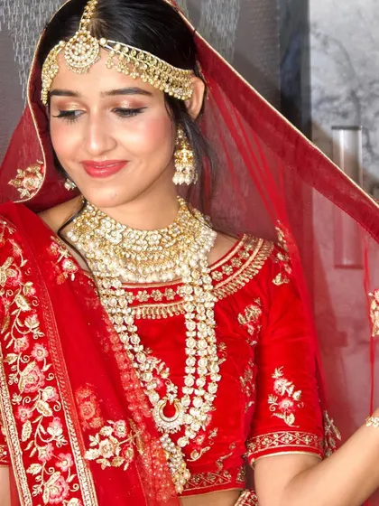 A classic red lehenga calls for a timeless makeup look. Here, I created a radiant and sophisticated style for the bride, ensuring her makeup was flawless and long-lasting for her main wedding ceremony.