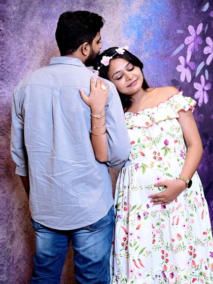A tender moment of affection between the expecting couple. Her peaceful expression and his gentle embrace make this a heartwarming maternity portrait.