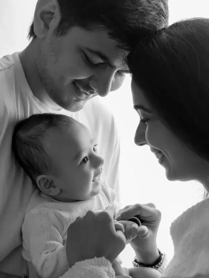 A timeless black and white photo capturing the adoring looks between parents and their new baby.