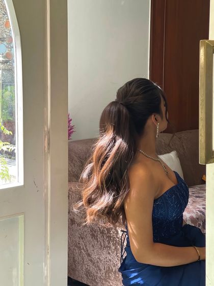 An artistic shot of the ponytail, with the light catching the waves beautifully. This is a great style for any party or special occasion.