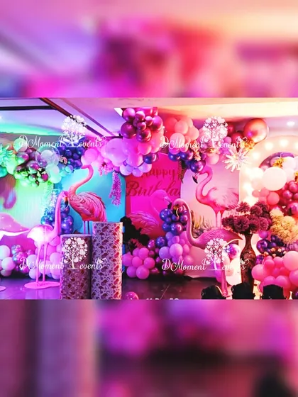Another angle of the Flamingo-themed stage, showing the depth and layers of the balloon decorations and props. The intense pink and purple lighting enhances the tropical party vibe.
