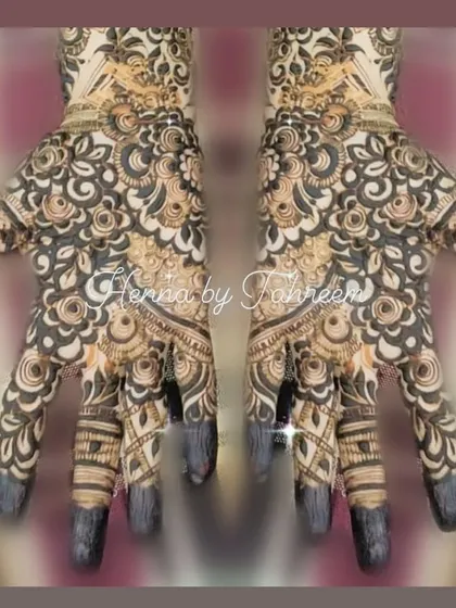 This mirrored design shows a perfectly symmetrical, heavy pattern on both hands. The tips of the fingers are fully covered in henna, a traditional style that gives a very rich stain.