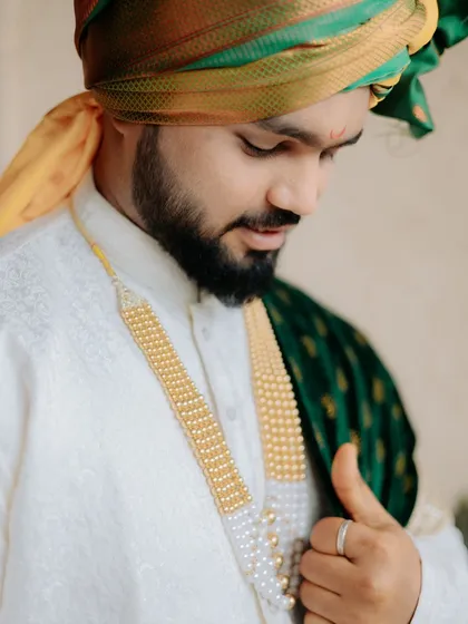 A detailed portrait of a groom in his traditional Maharashtrian wedding attire. I pay just as much attention to the groom's look, ensuring his style and personality are captured with care.