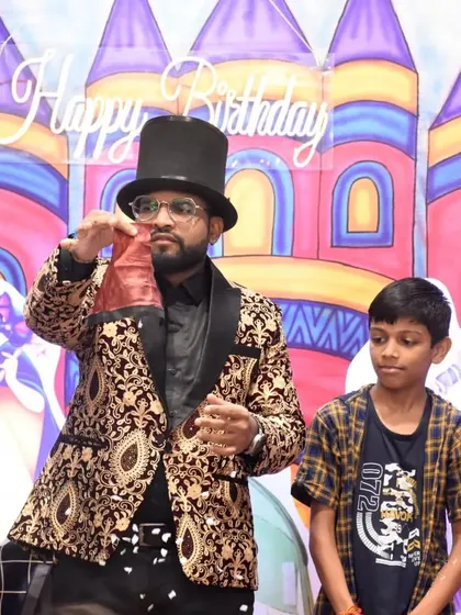 A young volunteer helps me with a classic bag trick. His focus and participation make the show even more entertaining for everyone.