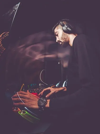 A fisheye lens captures me deep in concentration at the mixer, giving a sense of the immersive, high-energy environment of the DJ booth.