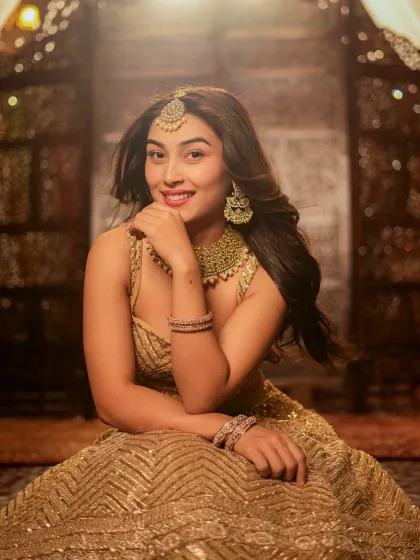 A classic portrait pose that beautifully showcases the jewelry and makeup.