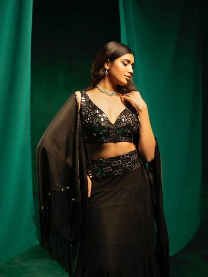 A close-up of the mirror-work blouse from 29 India's black lehenga set.