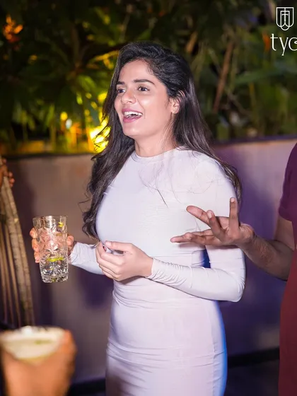 A guest enjoying a drink and the conversation.