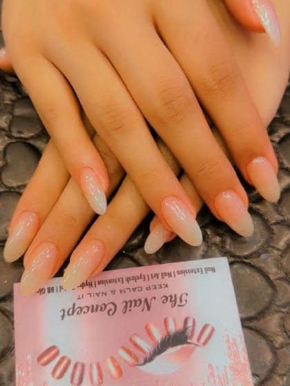 A beautiful set of long, almond-shaped extensions with a sheer, natural-looking nude polish. This is the perfect choice for an elegant and understated look.