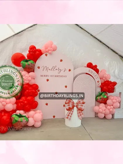 The full view of the rustic strawberry first birthday, set up inside a tent.