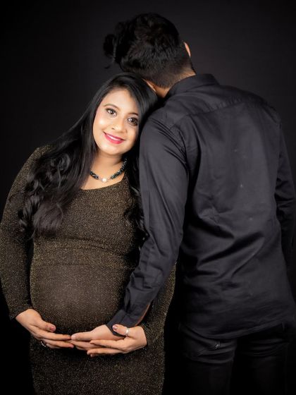 An intimate moment between the parents-to-be. The makeup is soft and romantic, enhancing her natural pregnancy glow.