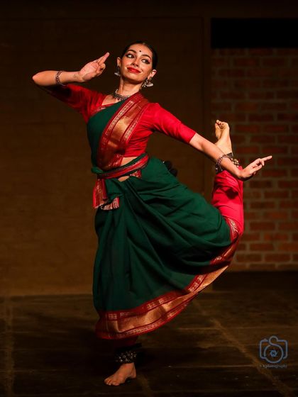 A dynamic pose from the same Natanakairali performance. The energy of the movement is balanced with a focused and expressive face.