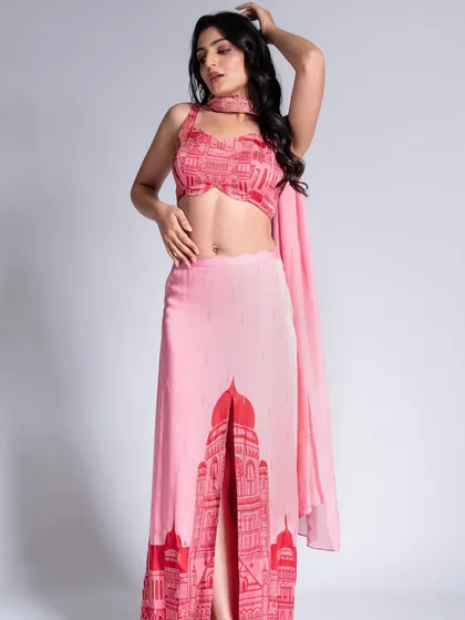 A full-length shot from the Label Shivani Nirupam campaign. The makeup is soft and pretty, with a focus on radiant skin to complement the pink printed outfit.