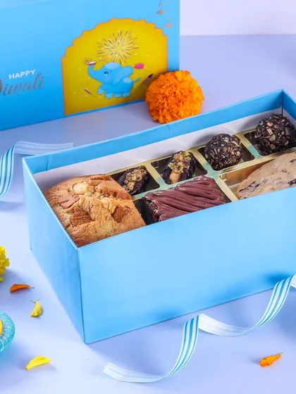 A closer look at one of our delectable Diwali dessert boxes. This one features a mix of our signature cookies, brownies, and chocolate truffles, perfect for sharing.