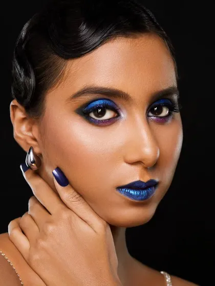 Here is a dive into creative and editorial makeup. This look features a bold, metallic blue lip and dramatic cobalt blue eyeshadow, paired with sleek, retro-inspired finger waves for a high fashion statement.
