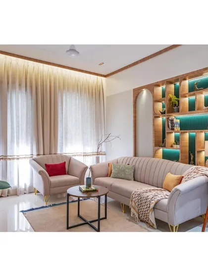 The full living room setup, showcasing the interplay of light from the large windows and the warm, ambient lighting from the ceiling. The space feels open, airy, and connected to the outdoors.