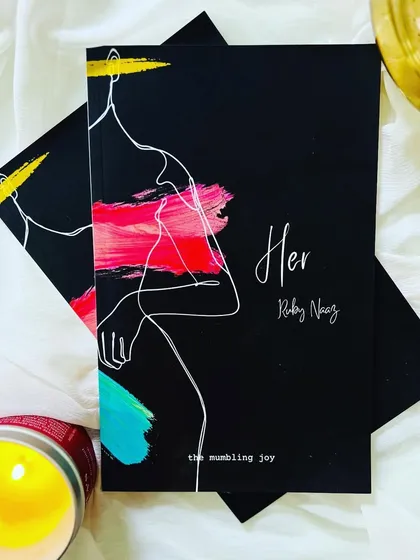 This is my debut poetry book, 'HER'. It's a collection of poems written for the feminine spirit that resides in all of us. Holding this book is a reminder that our words and stories deserve to be shared and cherished.